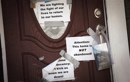 Signs are taped to the front door of a home in the New Dorp Beach area in the Staten Island borough of New York, September 20, 2013. REUTERS/Carlo Allegri