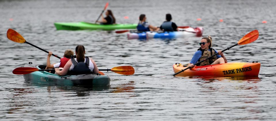 Canoes fill the water as people enjoy the outdoors during Summerfest at Sippo Lake Park in Perry Township.