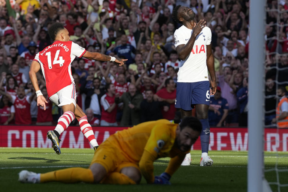 Arsenal's Pierre-Emerick Aubameyang, left, celebrates after scoring his side's second goal during the English Premier League soccer match between Arsenal and Tottenham Hotspur at the Emirates stadium in London, Sunday, Sept. 26, 2021. (AP Photo/Frank Augstein)