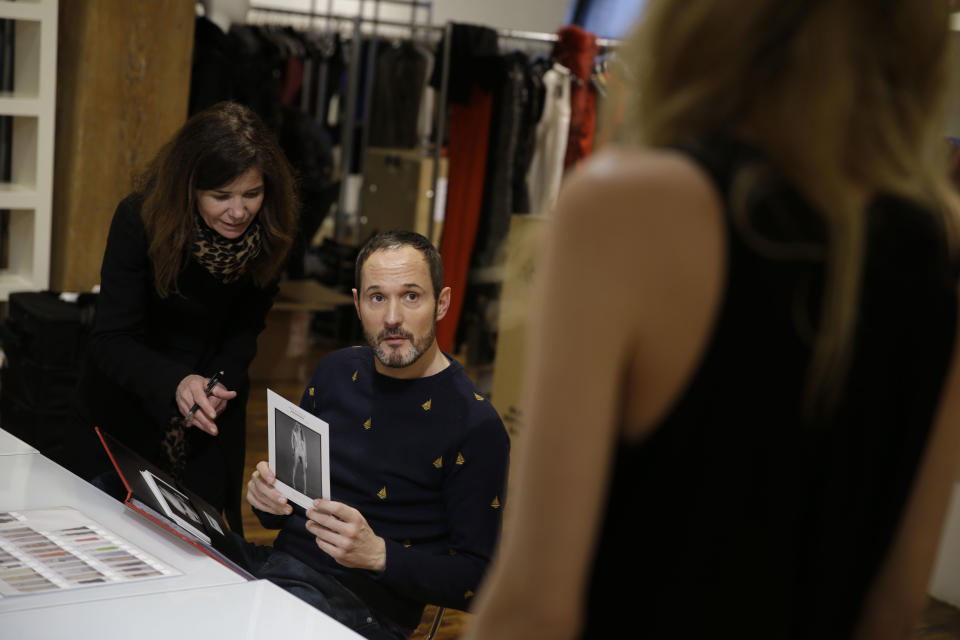 In this Monday, Feb. 3, 2014 photo, Josep Font, creative director of DelPozo, center, works with his casting director Esther Garcia during a model casting in New York. (AP Photo/Seth Wenig)