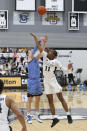 Providence's A.J. Reeves (11) blocks a shot by Villanova's Chris Arcidiacono (4) during an NCAA college basketball game in Providence, R.I., Saturday, March 6, 2021. (AP Photo/Stew Milne)