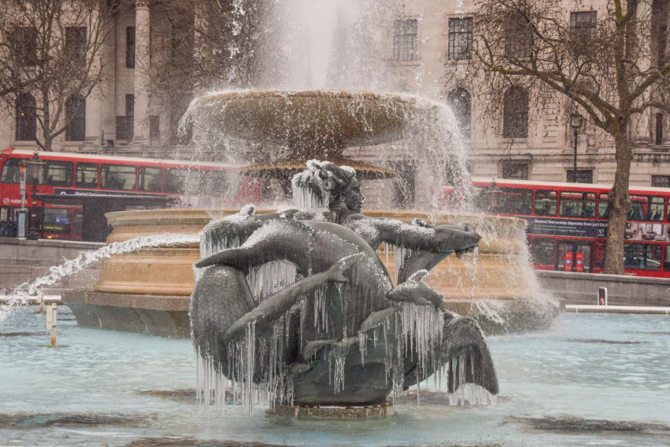 A fountain statue is covered in ice at Trafalgar Square in London. Storm Darcy has brought freezing temperatures to the UK, with much of the country covered in snow and ice. (Photo by Vuk Valcic / SOPA Images/Sipa USA)