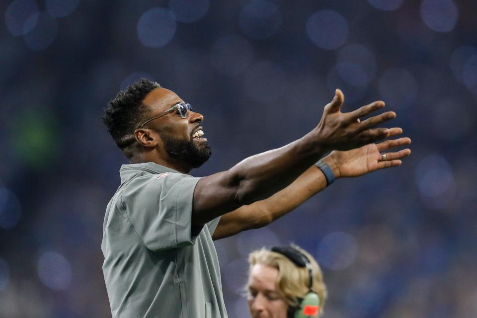 Former Detroit Lions receiver Calvin Johnson waves at fans during the first half against the Tampa Bay Buccaneers in the NFC divisional round at Ford Field in Detroit on Sunday, Jan. 21, 2024.