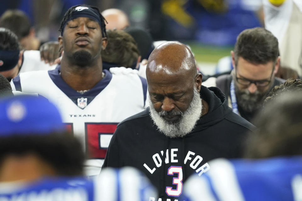 Houston Texans head coach Lovie Smith observes a moment of silence with Texans and Indianapolis Colts players before their NFL football game in support of Buffalo Bills safety Damar Hamlin, Sunday, Jan. 8, 2023, in Indianapolis. (AP Photo/Darron Cummings)