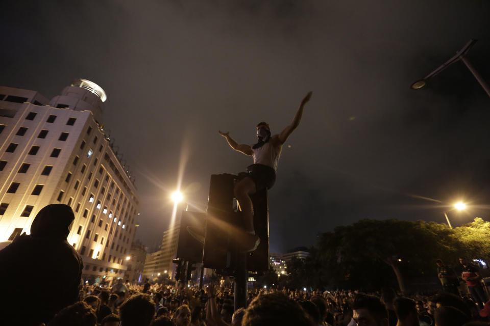 Anti-government protesters shout slogans against the Lebanese government in Beirut, Lebanon, Friday, Oct. 18, 2019. Lebanon erupted in protests Thursday over the government's plans to impose new taxes amid a severe economic crisis, taking their anger on politicians they accuse of widespread corruption and decades of mismanagement. (AP Photo/Hassan Ammar)