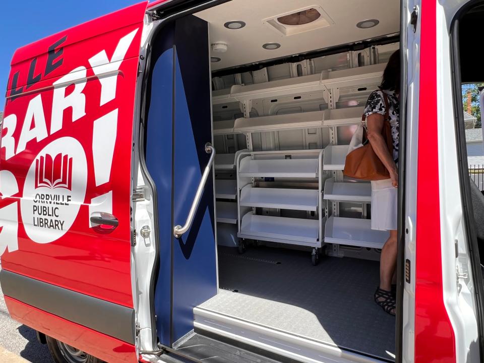 The Library on the Go vehicle designed by Farber Specialty includes bookshelves and cabinets to store books and crafts supplies.