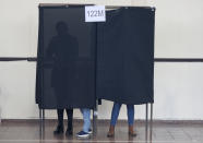 Residents vote in the Constitutional Convention election to select assembly members that will draft a new constitution, in Santiago, Chile, Saturday, May 15, 2021. The face of a new Chile begins taking shape this weekend as the South American country elects 155 people to draft a constitution to replace one that has governed it since being imposed during a military dictatorship. (AP Photo/Esteban Felix)