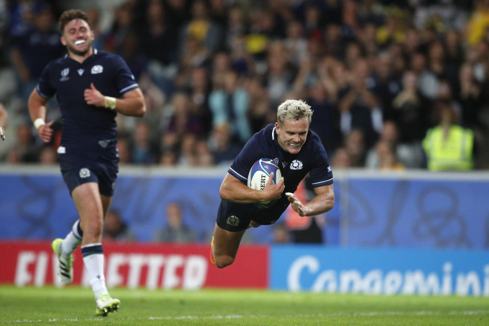 Scotland's Darcy Graham scores a try during the Rugby World Cup Pool B match between Scotland and Romania at the Stade Pierre Mauroy in Villeneuve-d'Ascq, outside Lille, France, Saturday, Sept. 30, 2023. (AP Photo/Michel Spingler)