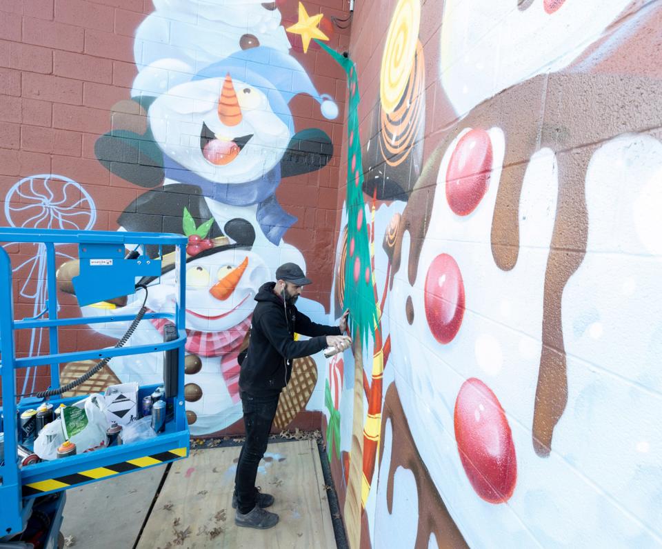 Canton-based artist Steve Ehret works on a holiday mural at the Factory of Terror as part of its new indoor Ohio Christmas Factory attraction. Featuring a 50,000-square-foot winter wonderland, Ohio Christmas Factory opens Saturday.