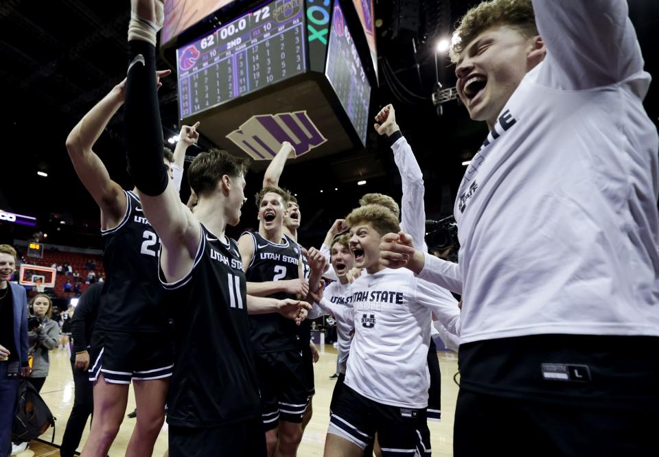 Utah State Aggies players celebrate after defeating Boise State at the Mountain West Conference Basketball Tournament.
