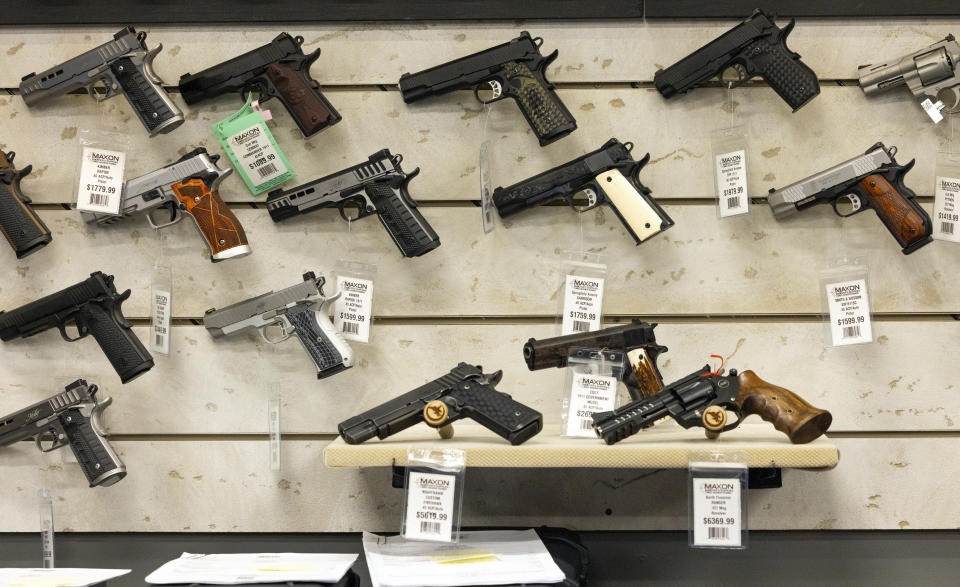 Guns for sale are displayed at Maxon Shooter's Supplies in Des Plaines, Ill., Tuesday, June 25, 2024. A new national divide is emerging among states over whether to track sales by gun stores. A California law taking effect Monday will require credit card networks to provide banks with special retail codes to assign to gun stores. By contrast, new laws taking effect in Georgia, Iowa, Tennessee and Wyoming will prohibit the use of special gun shop codes in financial transactions. A total of 17 states have passed some sort of limit on category codes for gun retailers, while California has been joined by Colorado and New York. (AP Photo/Teresa Crawford)