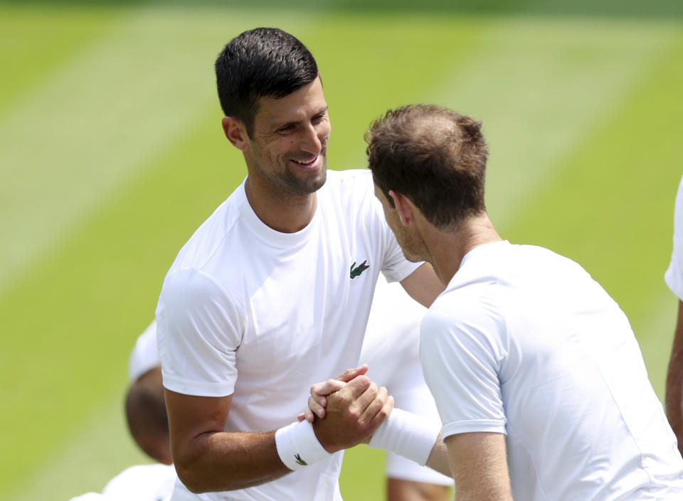 Serbia's Novak Djokovic greets Britain's Andy Murray as they practice at the All England Lawn Tennis and Croquet Club in Wimbledon, England ahead of the championships which start on Monday, Thursday June 29, 2023. (Steven Paston/PA via AP)