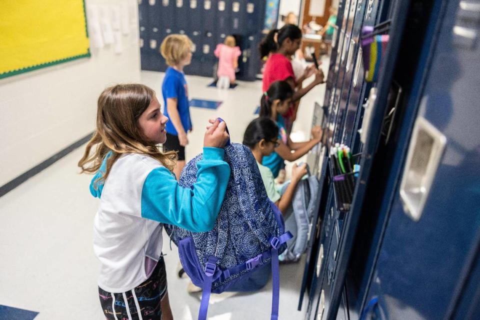 Students set up their lockers during the first day of school at Lake Norman Charter Middle School in Huntersville, N.C., on Thursday, August 10, 2023.