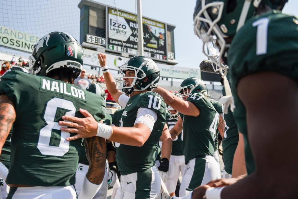 Payton Thorne, center, rallies with the team before Michigan State's football game against Youngstown State on Saturday, Sept. 11, 2021, in East Lansing.