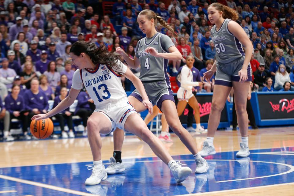 Kansas super-senior guard Holly Kersgieter (13) controls the ball from Kansas State during the first half of the Sunflower Showdown game Sunday inside Allen Fieldhouse.