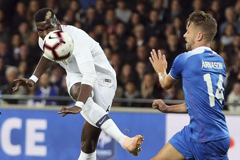 France's Paul Pogba, left, kicks the ball during a friendly soccer match between France and Iceland, in Guingamp, western France, Thursday, Oct. 11, 2018. (AP Photo/David Vincent)