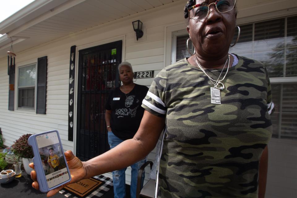 Desiree Miles, right, on Tuesday shows a photo of 5-year-old Zoey Felix. Miles, along with Sheryl Tyree, left, had helped clean Zoey and fixed her hair earlier this year when this photo was taken.