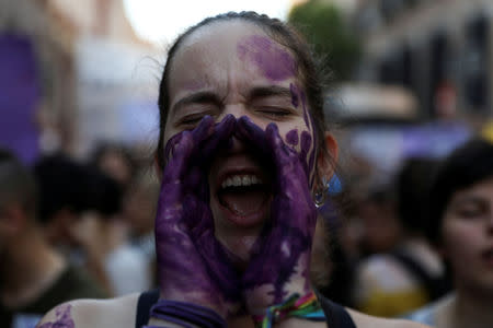 FILE PHOTO: A protester shouts slogans during a demonstration against the release on bail of five men known as the "Wolf Pack" cleared of a gang rape of a teenager and convicted of a lesser crime of sexual abuse in Madrid, Spain, June 22, 2018. REUTERS/Susana Vera/File Photo