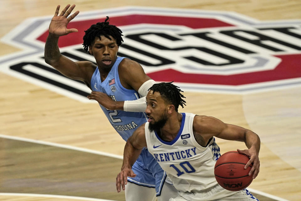Kentucky's Davion Mintz (10) drives past North Carolina's Caleb Love (2) in the second half of an NCAA college basketball game, Saturday, Dec. 19, 2020, in Cleveland. North Carolina won 75-63. (AP Photo/Tony Dejak)