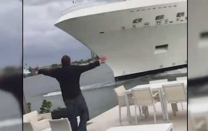 Mr Todhunter waves his arms to warn the cruise liner. Picture: WPLG