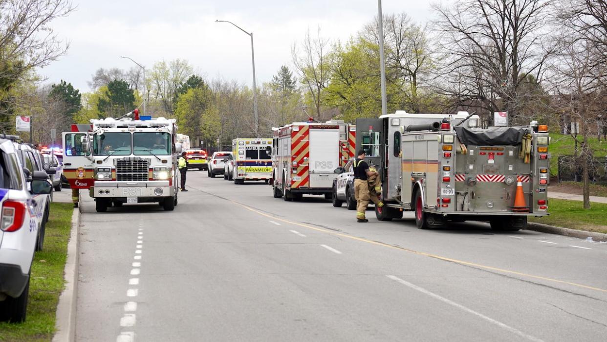 Emergency vehicles line Donald Street in Overbrook after a fire started on the third floor of a highrise building early Thursday morning.               (Patrick Louiseize/CBC - image credit)
