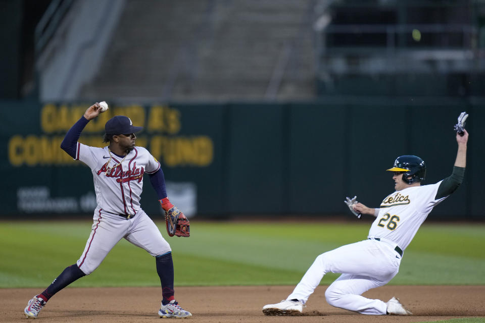 Atlanta Braves second baseman Ozzie Albies throws to first for a double play after forcing out Oakland Athletics' Jonah Bride at second during the seventh inning of a baseball game in Oakland, Calif., Tuesday, May 30, 2023. Shea Langeliers was out at first. (AP Photo/Godofredo A. Vásquez)