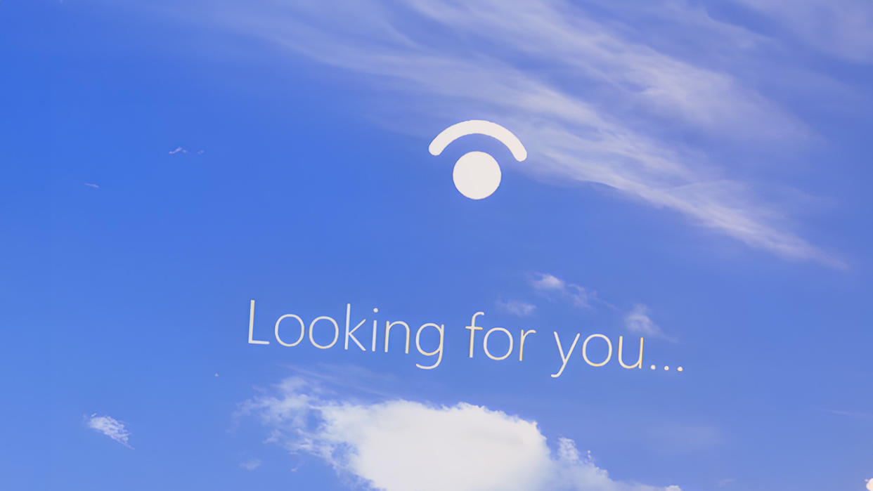  Windows Hello login screen with 'looking for you' text. 