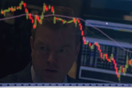 A specialist trader is reflected on his screen on the floor of the New York Stock Exchange August 25, 2015. REUTERS/Brendan McDermid