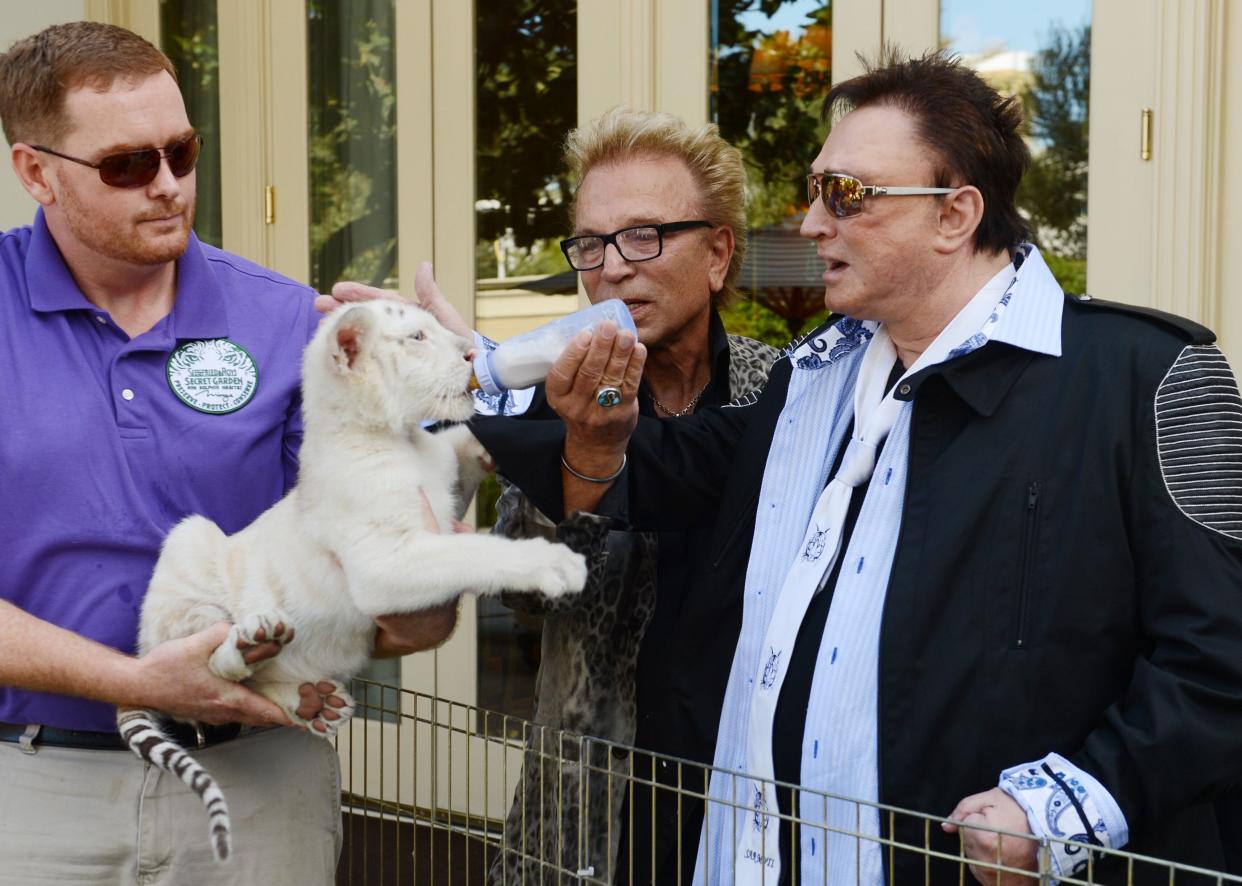 Siegfried Fischbacher, center, and Roy Horn at The Mirage Hotel &amp; Casino on Oct. 22, 2015, in Las Vegas. (Photo: Denise Truscello/WireImage via Getty Images)