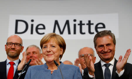 Christian Democratic Union CDU party leader and German Chancellor Angela Merkel reacts on first exit polls in the German general election (Bundestagswahl) in Berlin, Germany, September 24, 2017. REUTERS/Kai Pfaffenbach