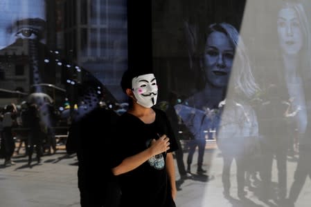 An anti-government protester wearing a mask attends a lunch time protest, after local media reported on an expected ban on face masks under emergency law, at Central, in Hong Kong
