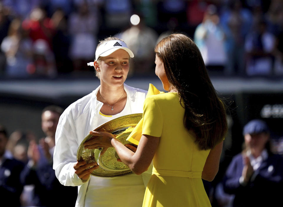 Kazakhstan's Elena Rybakina is presented with the trophy by Kate, Duchess of Cambridge after beating Tunisia's Ons Jabeur to win the final of the women’s singles on day thirteen of the Wimbledon tennis championships in London, Saturday, July 9, 2022. (Zac Goodwin/PA via AP)