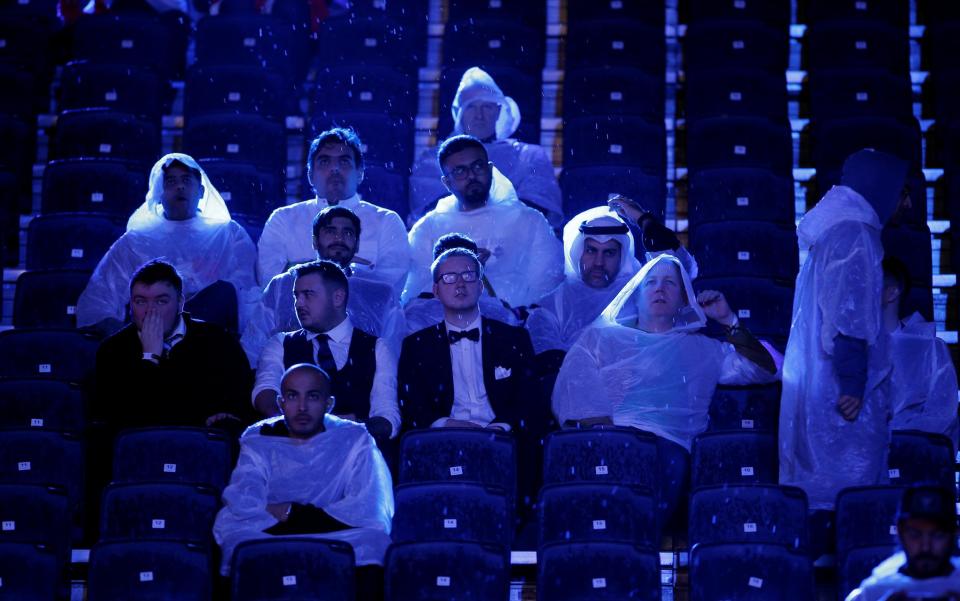 Some spectators had to take cover from the rain in Diriyah. (Action Images via Reuters)