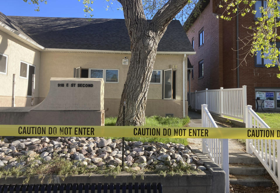 FILE - The fire-damaged Wellspring Health Access clinic is cordoned by tape on May 25, 2022, in in Casper, Wyo. A woman was arrested for setting fire to the building in Wyoming that was being renovated to house the state’s only full-service abortion clinic, authorities said Wednesday, March 22, 2023. (AP Photo/Mead Gruver, File)