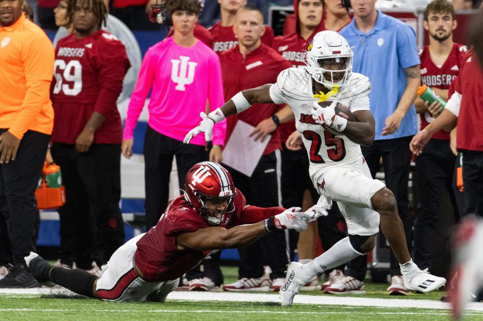 Louisville Cardinals running back Jawhar Jordan (25) runs the ball against Indiana Hoosiers linebacker Jacob Mangum-Farrar (7) in the second half at Lucas Oil Stadium on Sept. 16, 2023 in Indianapolis, Indiana.