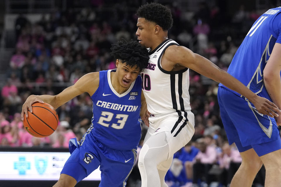 Creighton guard Trey Alexander (23) drives toward the basket as Providence guard Noah Locke (10) defends in the first half of an NCAA basketball game, Tuesday, Feb. 14, 2023, in Providence, R.I. (AP Photo/Steven Senne)