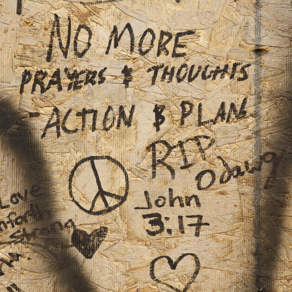 Messages people wrote are shown on a makeshift memorial, Tuesday, July 24, 2018, in Toronto, for the victims of Sunday's shooting. Canadian investigators said Tuesday there was no link to terrorism in the mass shooting that killed two people and wounded 13 as they continued to probe the life of the 29-year-old gunman for clues to what prompted the rampage that targeted diners at restaurants and cafes in a popular Toronto neighborhood. (Mark Blinch/The Canadian Press via AP)