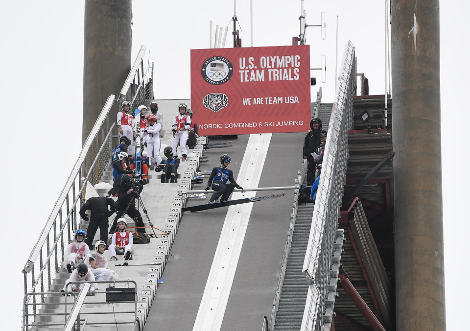 FILE - Andrew Urlaub (5) moves into the starting position for a jump during the men's ski jumping trials for the U.S. Olympic team at the Olympic Ski Jumping Complex on Saturday, Dec. 25, 2021, in Lake Placid, N.Y. The International Ski and Snowboard Federation is hosting a World Cup ski jumping competition Saturday and Sunday in Lake Placid, bringing the best in the sport back to town for the first time since 1990 and to the United States for the first time in nearly two decades. (AP Photo/Hans Pennink, File)