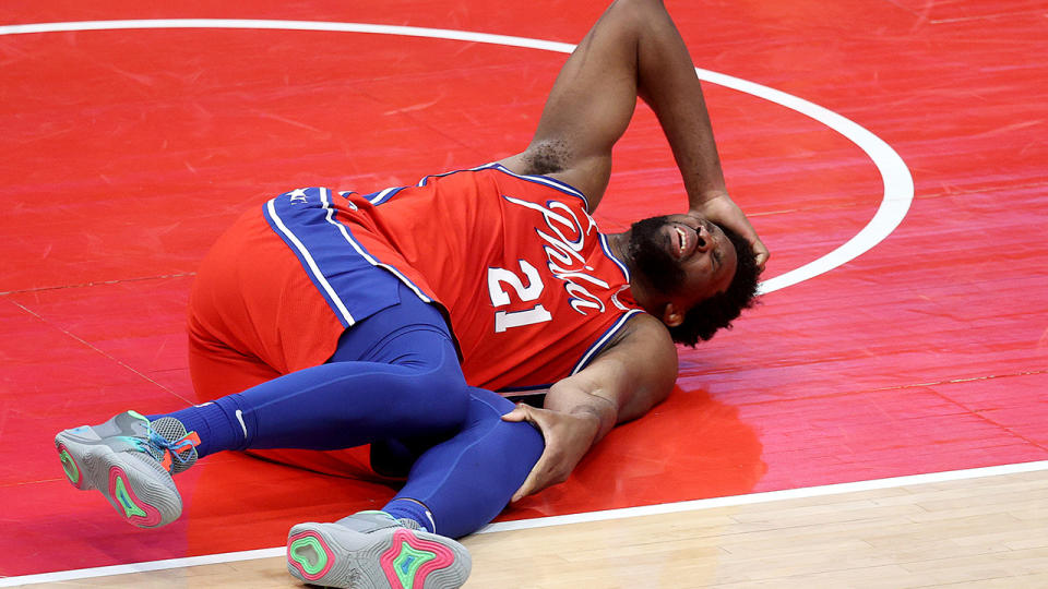 Joel Embiid will miss the next two to three weeks after suffering a bone bruise in his left knee. (Photo by Rob Carr/Getty Images)