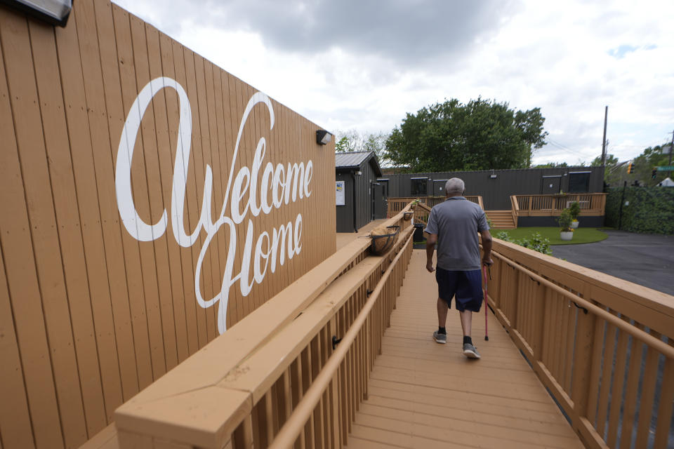 Melody resident Otis Johnson walks from his apartment Friday, April 12, 2024, in Atlanta. The Melody is a housing complex made from shipping containers and is intended to help house people from Atlanta's homeless population. (AP Photo/John Bazemore)