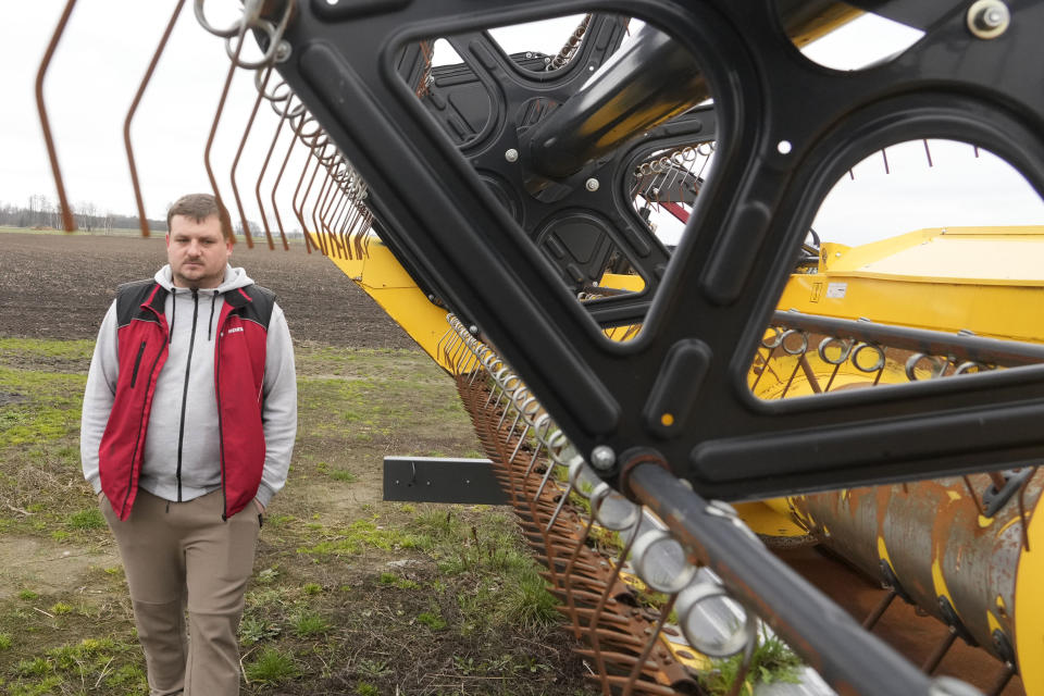 Piotr Korycki, a 34-year-old Polish farmer, walks past machinery on his farm in Cywiny Wojskie, Poland, on Monday March 18, 2024. Piotr says his business has been badly destabilized by Russia’s war against Ukraine and that the European Union is only adding to his problems. He's among the large number of farmers who have protested across Europe for months, and he’s organizing the latest protest planned for Poland on Wednesday. (AP Photo/Czarek Sokolowski)