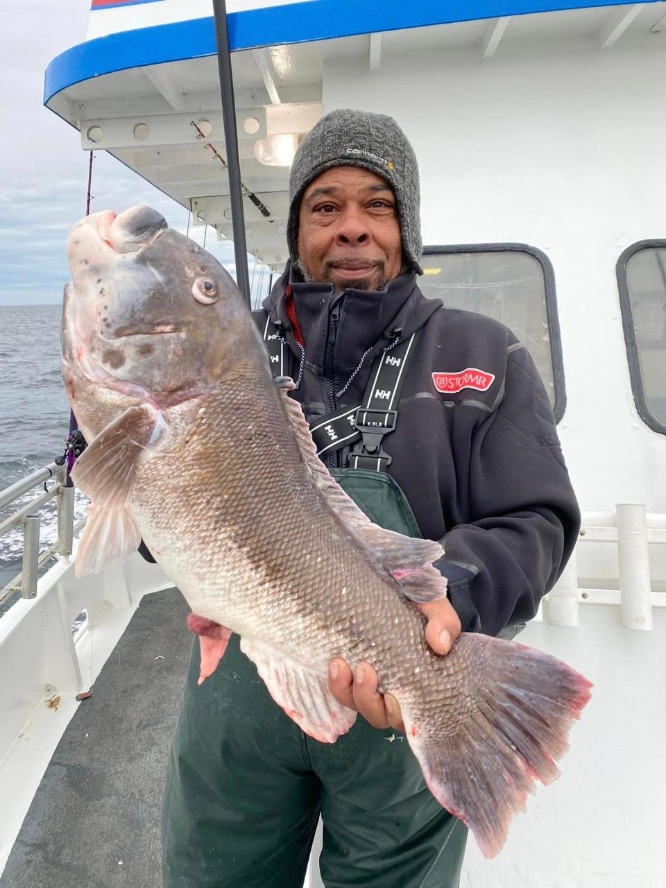 Kareem Troutman holds a 12-pound blackfish he caught on the Jamaica II.