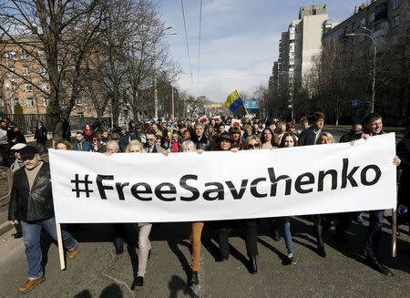 People take part in a rally demanding the liberation of Ukrainian army pilot Nadezhda Savchenko by Russia, in Kiev, Ukraine, March 8, 2016. REUTERS/Valentyn Ogirenko