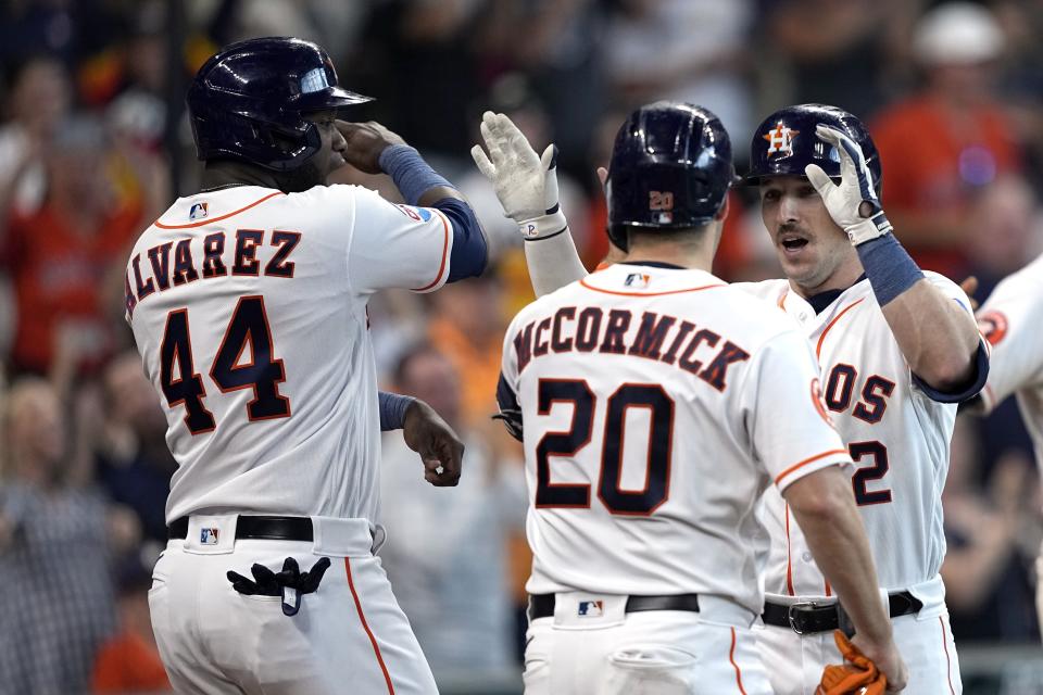 Houston Astros' Alex Bregman (2) celebrates with Chas McCormick (20) and Yordan Alvarez (44) after hitting a grand slam against the Los Angeles Angels the fourth inning of a baseball game Saturday, June 3, 2023, in Houston. (AP Photo/David J. Phillip)
