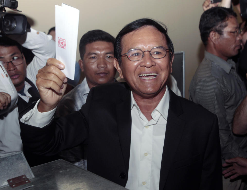 FILE - In this June 4, 2017, file photo, then opposition Cambodia National Rescue Party President Kem Sokha shows off his ballot before voting in local elections in Chak Angre Leu on the outskirts of Phnom Penh, Cambodia. A Cambodian government spokesman says Kem Sokha who has been held been for a year on a treason charge, was released on bail Monday, Sept. 10, 2018. (AP Photo/Heng Sinith, File)
