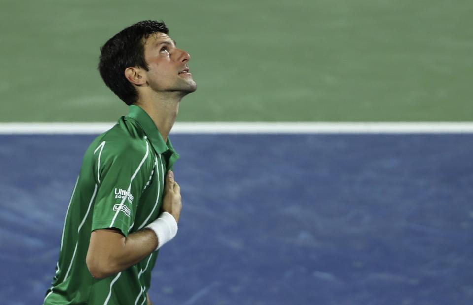 Serbia's Novak Djokovic celebrates after he beats Gael Monfils of France in a semi final match of the Dubai Duty Free Tennis Championship in Dubai, United Arab Emirates, Friday, Feb. 28, 2020. (AP Photo/Kamran Jebreili)