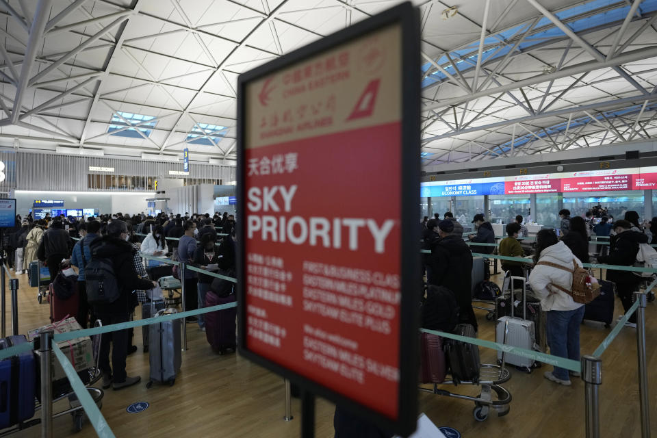 Passengers wait in line to board a plane to China at the Incheon International Airport in Incheon, South Korea, Tuesday, Jan. 10, 2023. China suspended visas Tuesday for South Koreans to come to the country for tourism or business in apparent retaliation for COVID-19 testing requirements on Chinese travelers. (AP Photo/Ahn Young-joon)