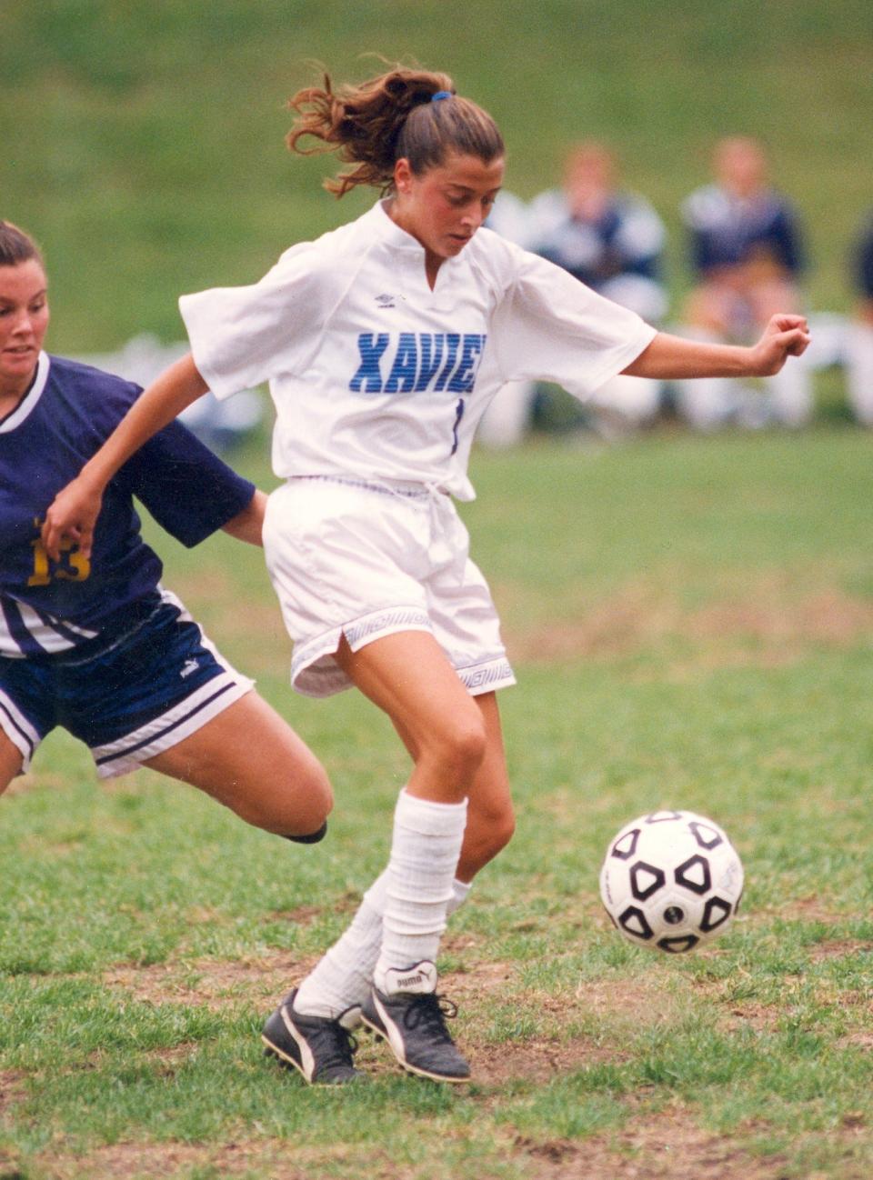 Amanda Gruber, a graduate of St. Ursula Academy, re-wrote the Xavier soccer record books. She still holds the school records for the most goals in a season (24 in 1997) and a career (67), most points in a season (59 in 1997) and a career (160).