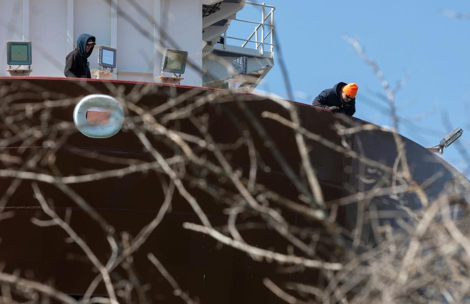 Two people on the Mark W. Barker, a large freighter that ran aground on the Canadian side of Belle Isle, look at the bottom of the freighter in Detroit on Wednesday, May 17, 2023.