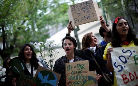 People attend a demonstration to demand more protection for the Amazon rainforest, at the Brazilian embassy in Mexico City